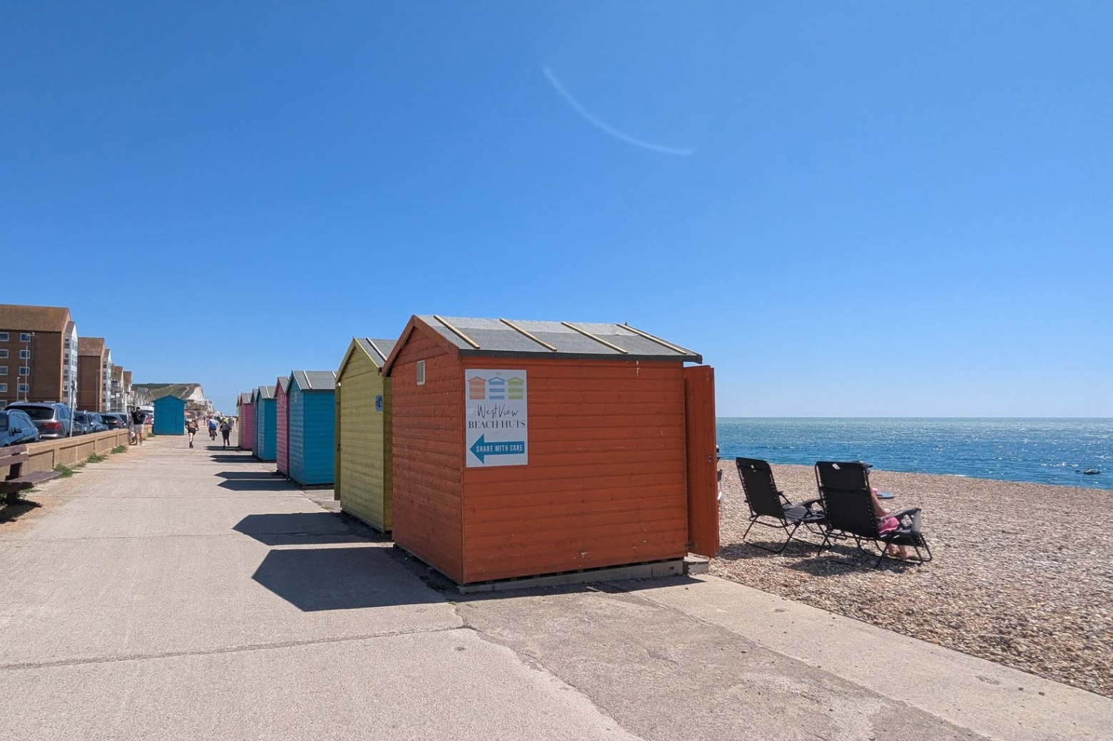 blue skies and colourful beach huts on Seaford Esplande 